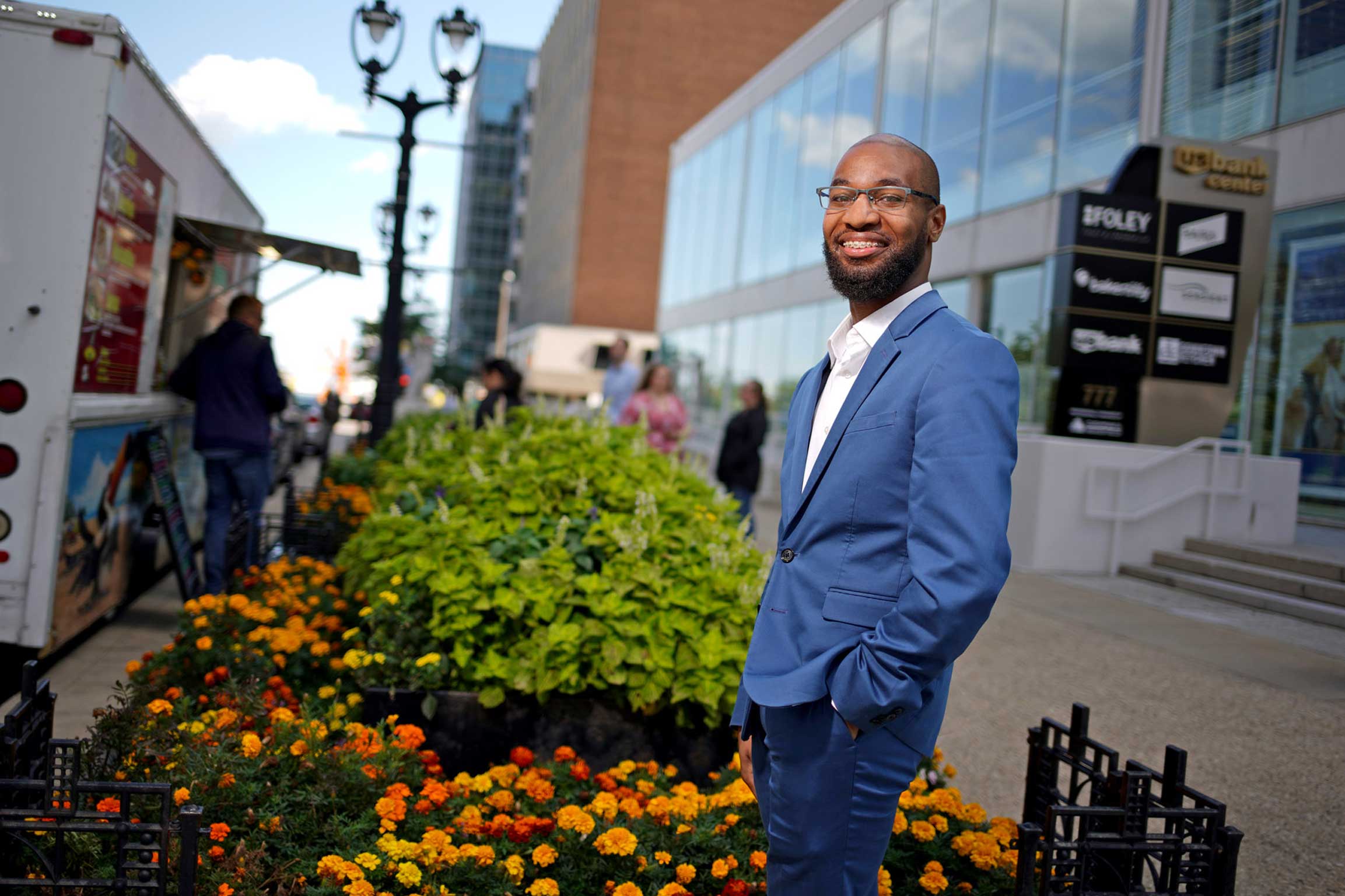 Scholarship recipient Jaylin Durham stands in front of the US Bank building where he works.