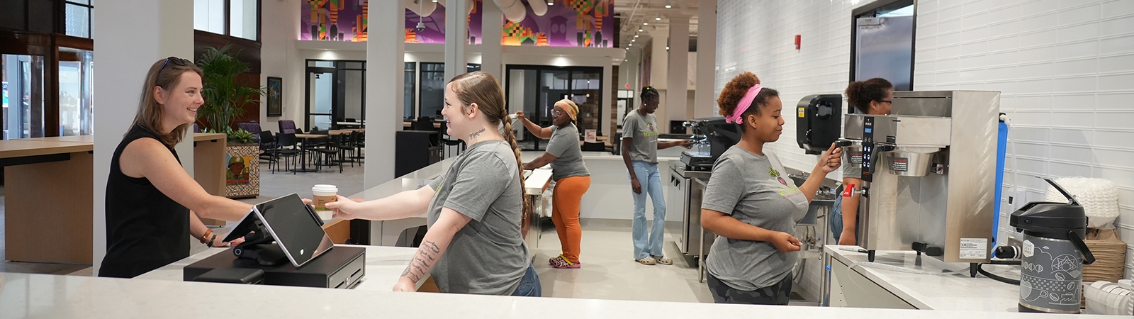 Employees prepare and serve customers at ThriveOn King's Kinship café