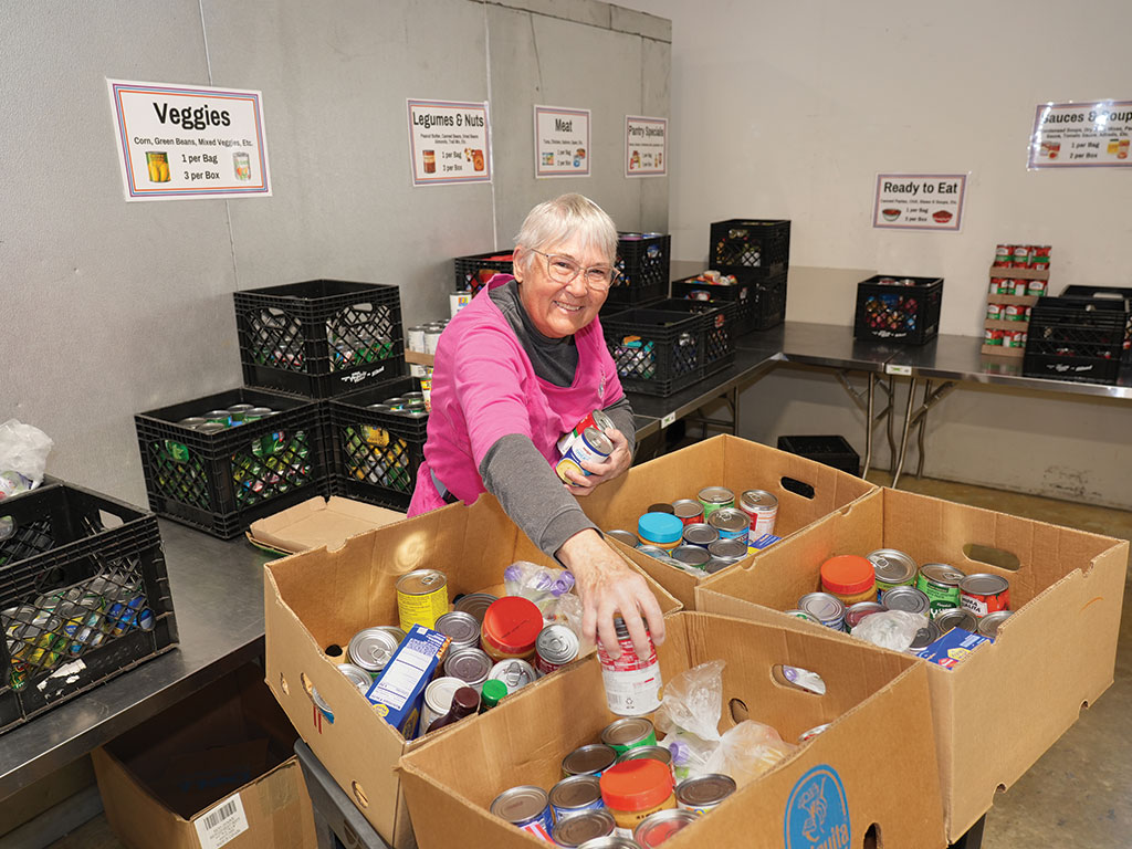 A Food Pantry of Waukesha County volunteer sorts food at the nonprofit’s warehousA Food Pantry of Waukesha County volunteer sorts food at the nonprofit’s warehouse.