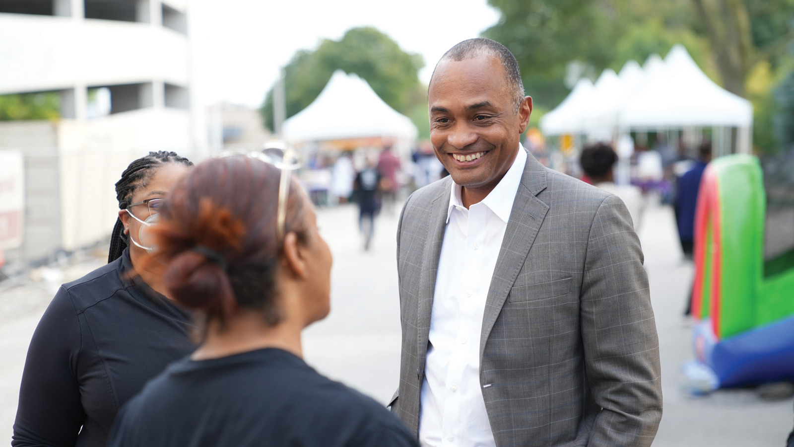 Foundation President and CEO Greg Wesley chats with a community member at the ThriveOn King block party