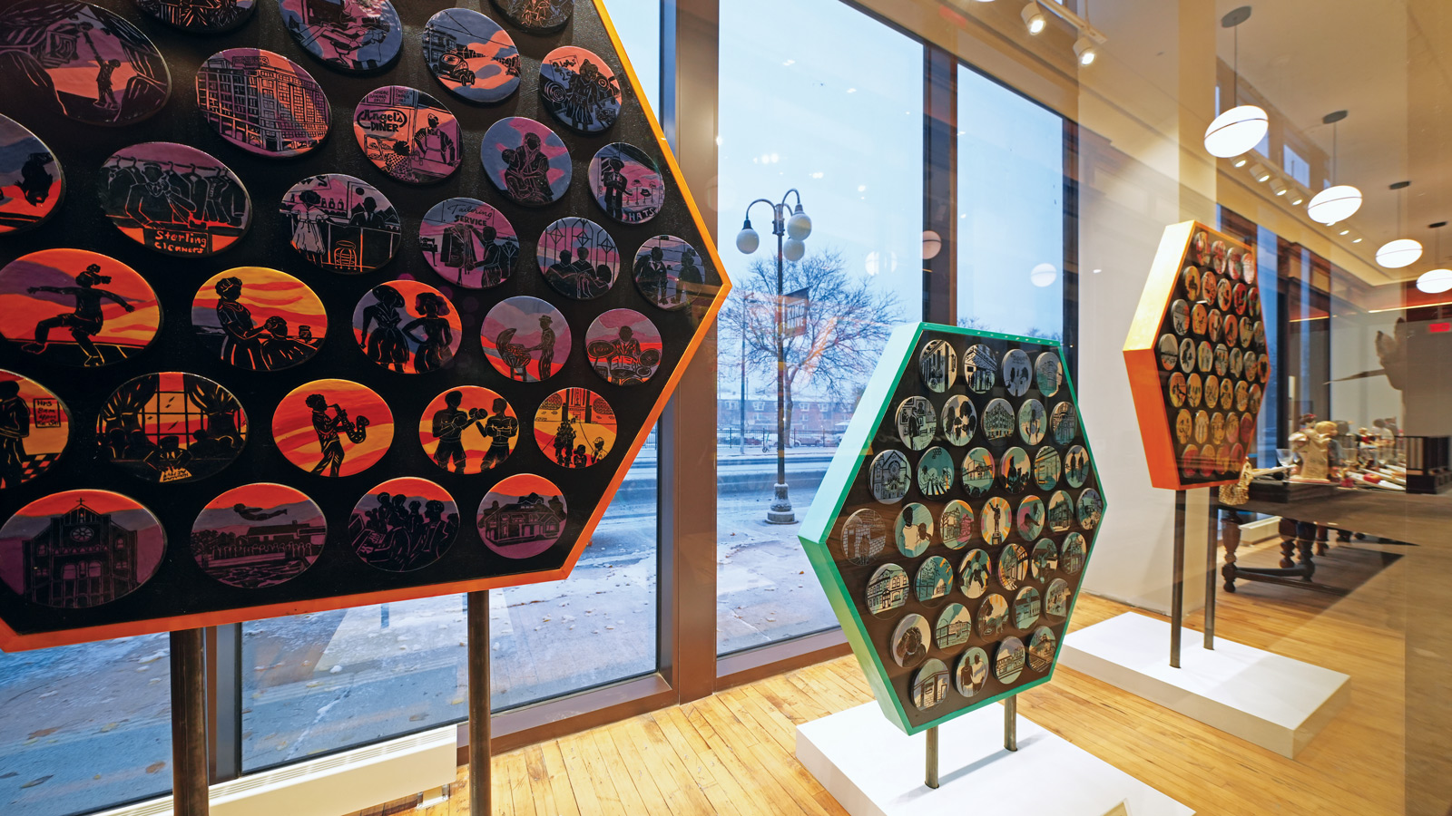 Bronzeville: Remembering the Past, Living the Present and Visioning the Future created by La Familia de Arte, which is featured in a window display case at ThriveOn King.